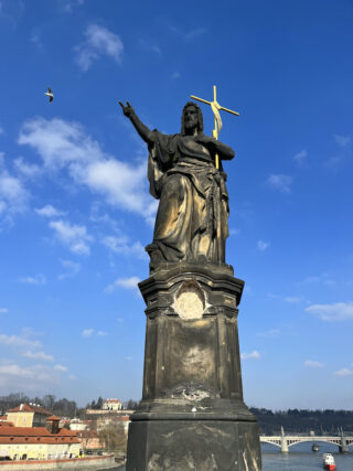 Baroque stone statue of saint John Baptist on the Charles Bridge of Prague