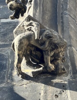 A lion catching a rabbit. Statue of the Old town tower of the Charles Bridge. 
