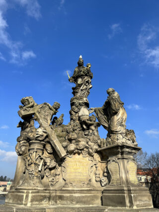 Baroque stone statue of saint Bernard on the Charles Bridge of Prague