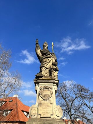 Baroque stone statue of saint Augustin on the Charles Bridge of Prague
