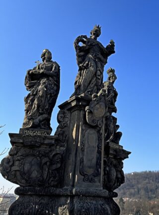 Baroque stone statue of saint Barbara on the Charles Bridge of Prague