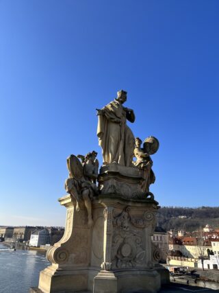 Baroque stone statue of saint Francis on the Charles Bridge of Prague