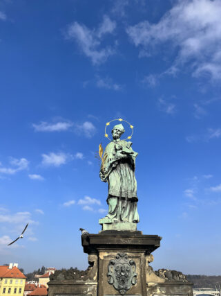 Baroque stone statue of saint John Nepomuk on the Charles Bridge of Prague