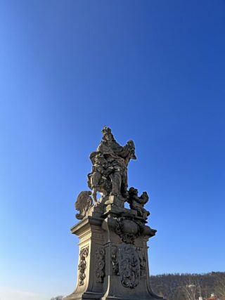 Baroque stone statue of saint Ludmila on the Charles Bridge of Prague