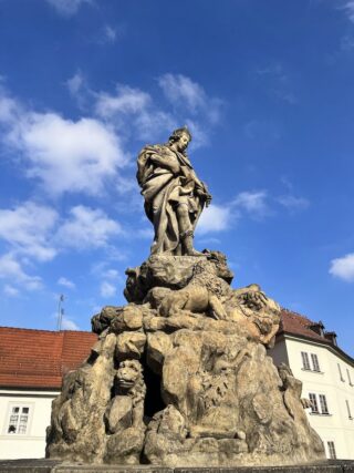 Baroque stone statue of saint Vitus on the Charles Bridge of Prague
