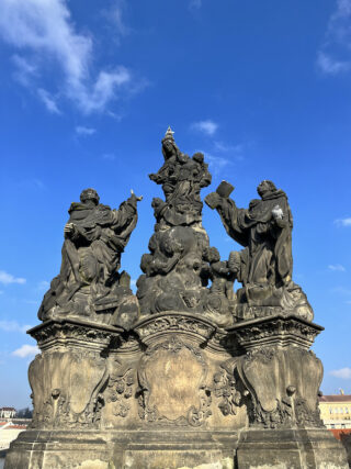 Baroque stone statue of saint Thomas on the Charles Bridge of Prague